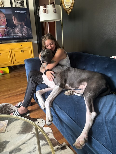 Bo and his owner hugging on couch.