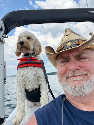 Guinness and his owner enjoying the breeze on their boat.