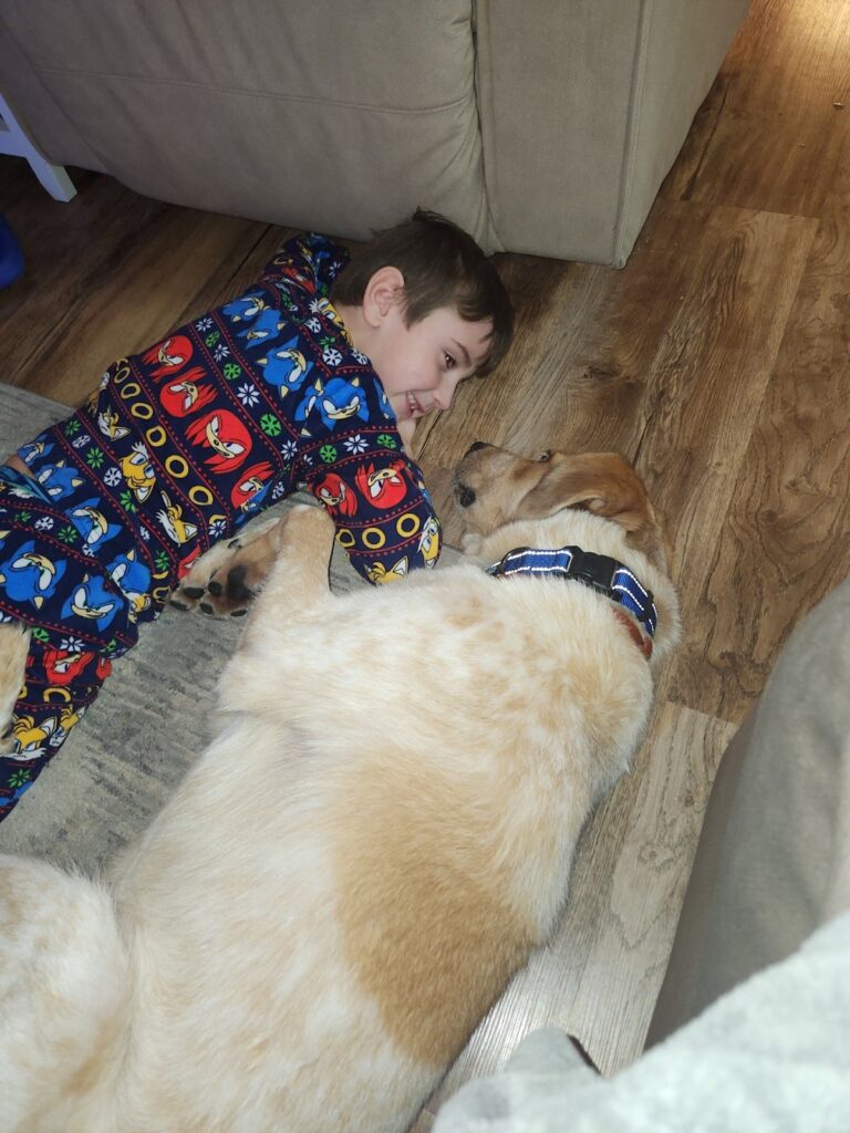 Jason and his adopter laying on the floor together.