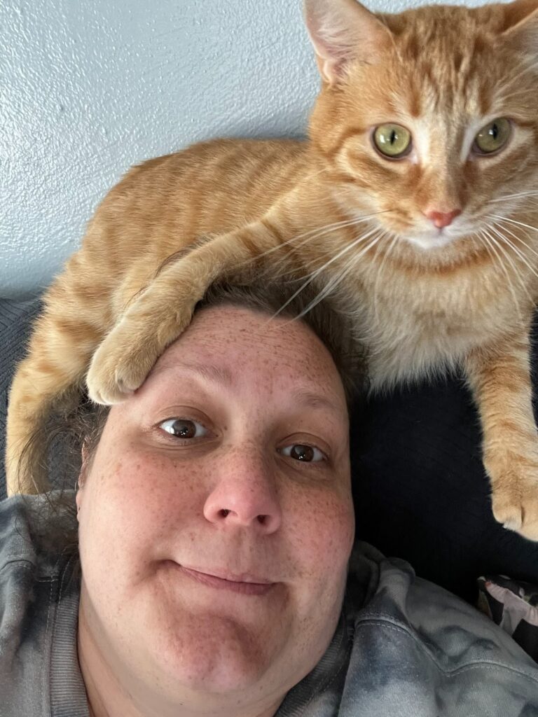 Mango resting her paw on her owner.