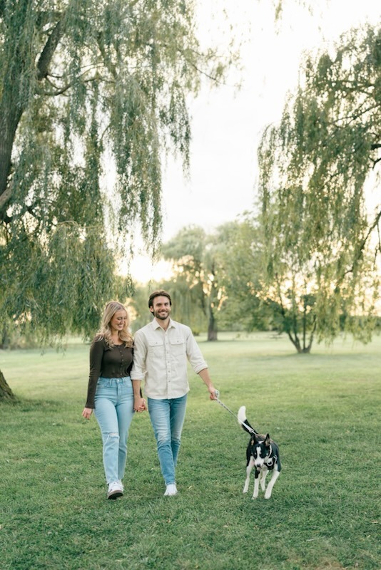 Nutmeg and his owners walking through the park.
